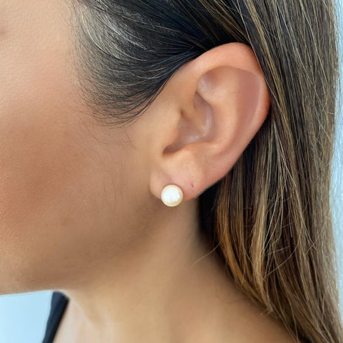White medium pearl studs close up