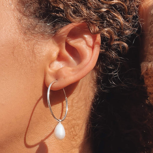 Emily Silver hoops close up on ear
