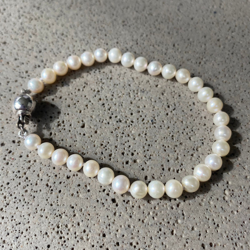 White pearl bracelet on surface