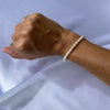 Single strand white pearl bracelet on arm