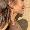 Gold Hoop Earrings on a smiling model