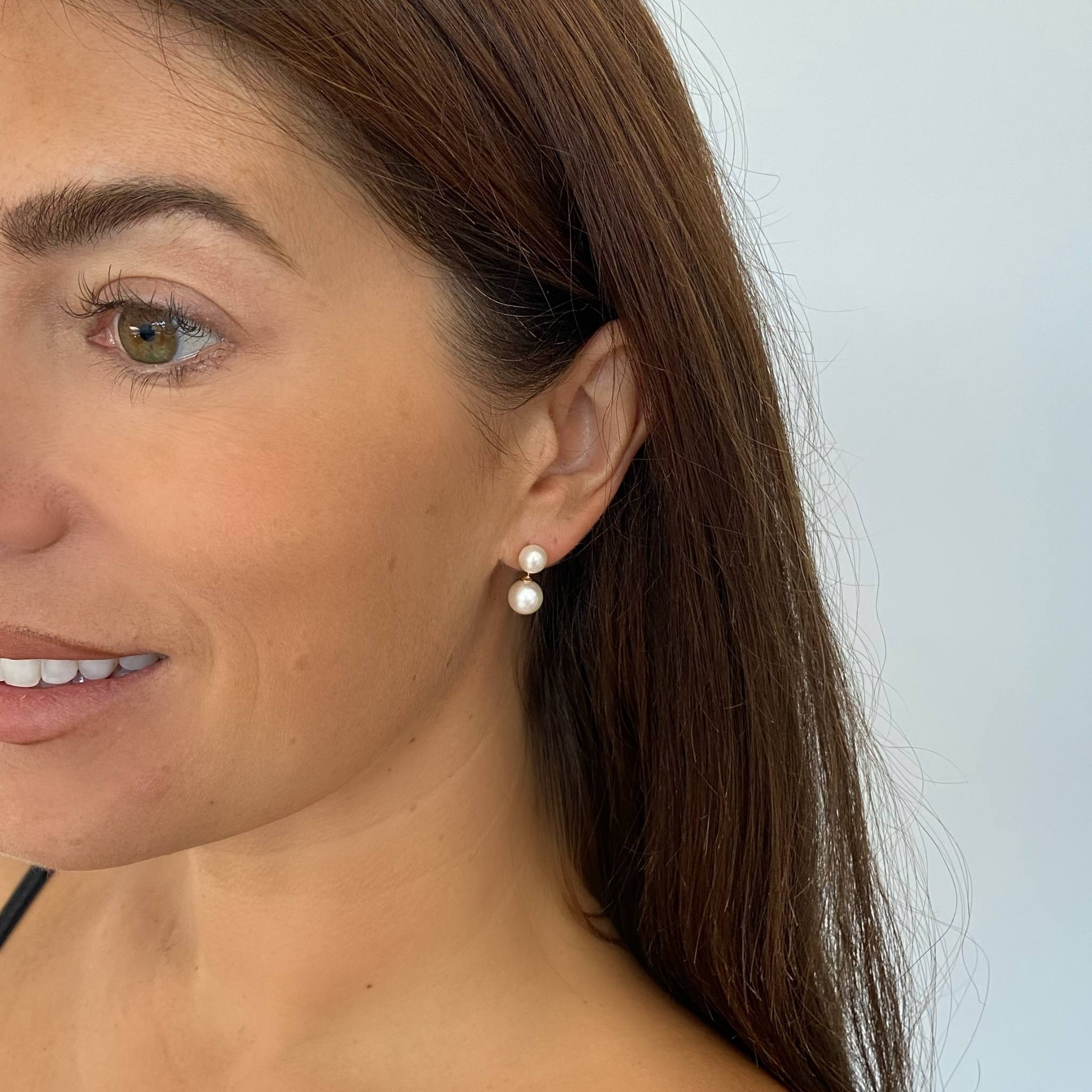 paid earrings on a model smiling