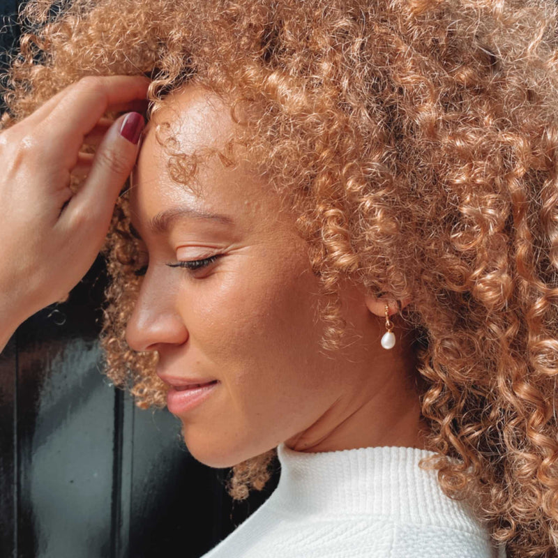 Rebecca Small hoop earrings in 14k Yellow Gold on a Model