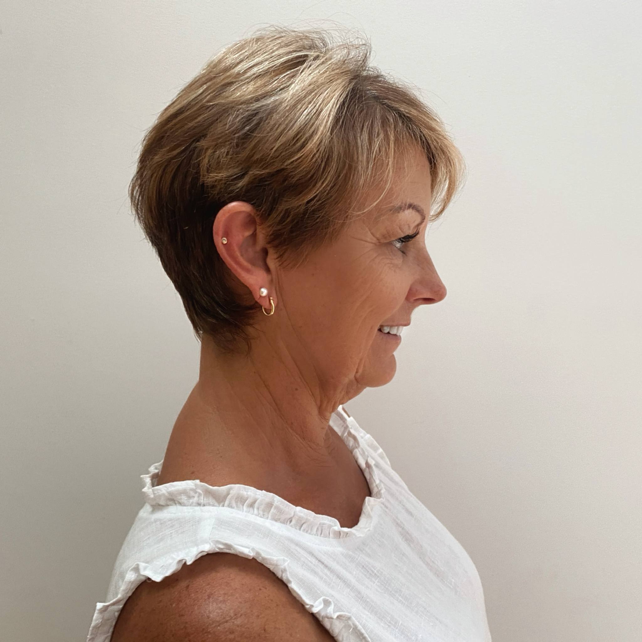 Small white pearl studs on an older model